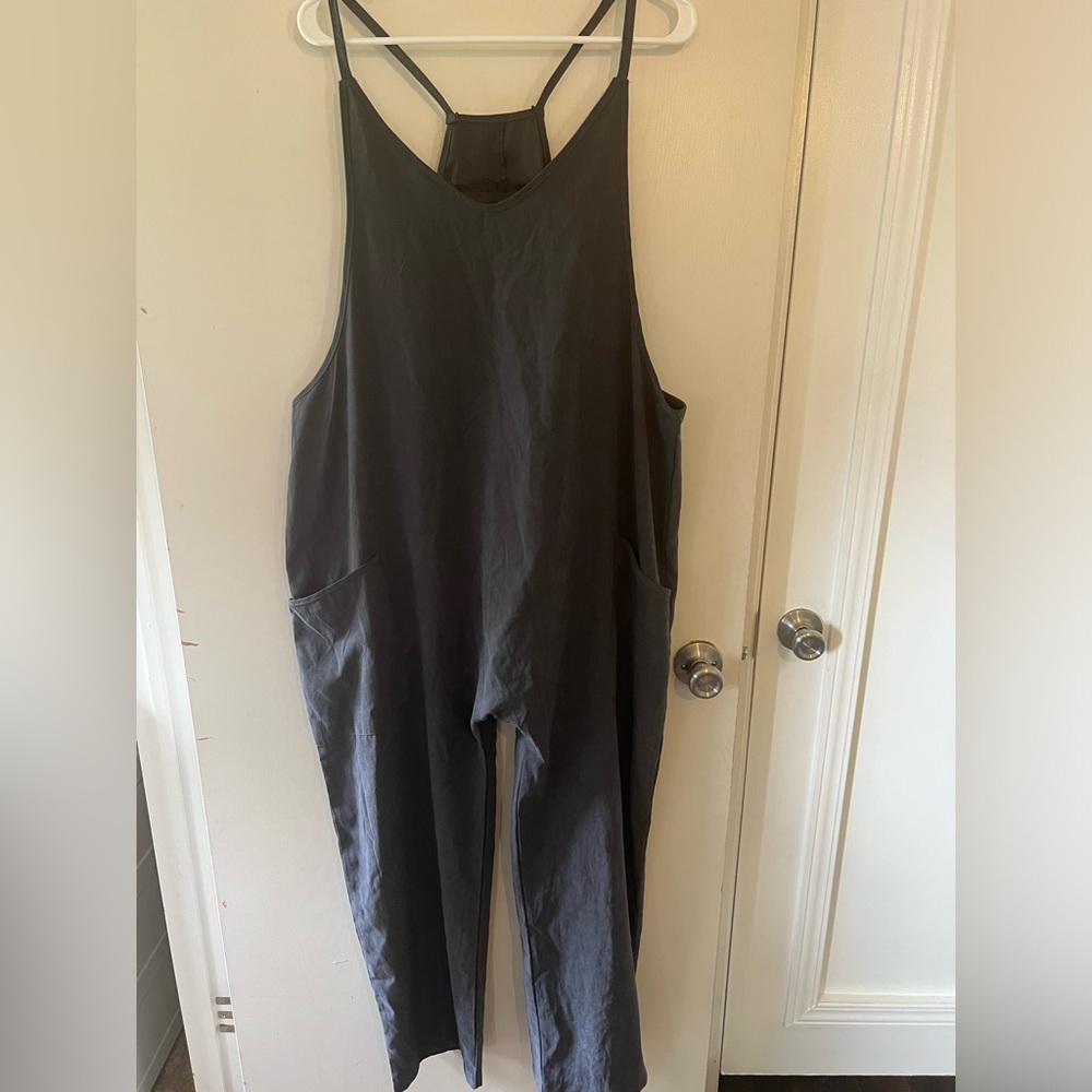 Navy blue romper with pockets and small zipper detail on back.
